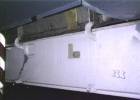 Nose gear door interior, looking starboard and forward. Door interior is white, bay interior is mostly light aircraft grey with black and zinc chromate green bits.